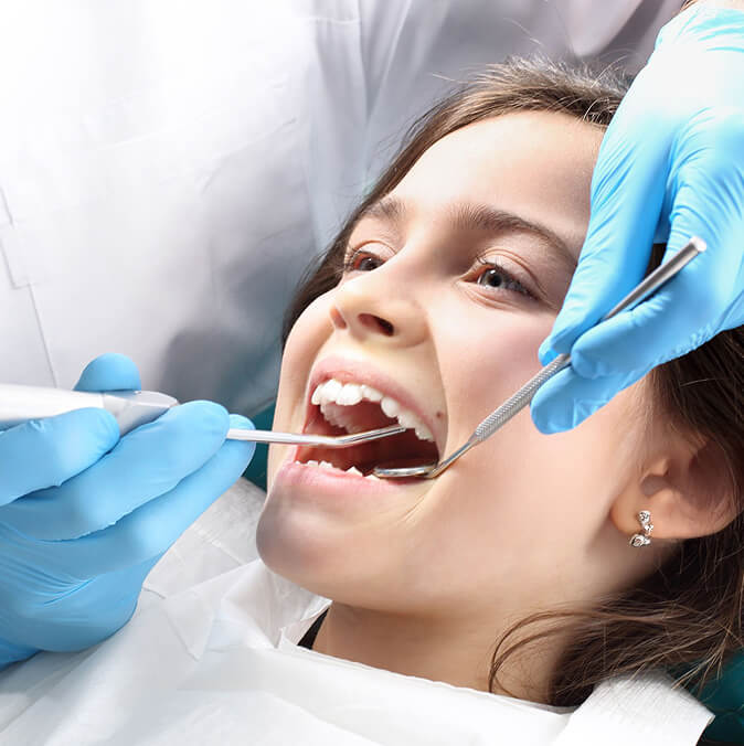 Child Undergoing Dental Checkup with Dentist