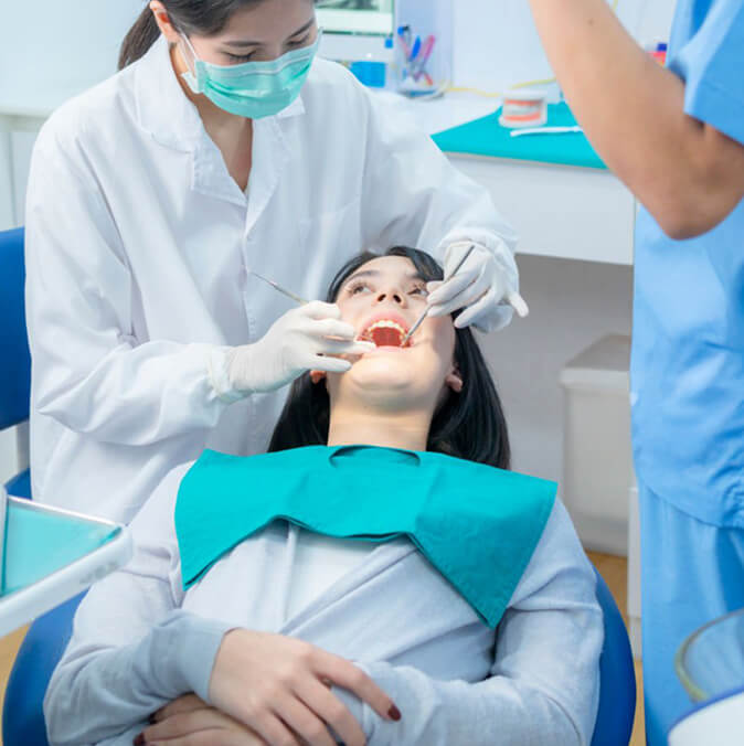 Dentist Examining Patient During Routine Dental Checkup
