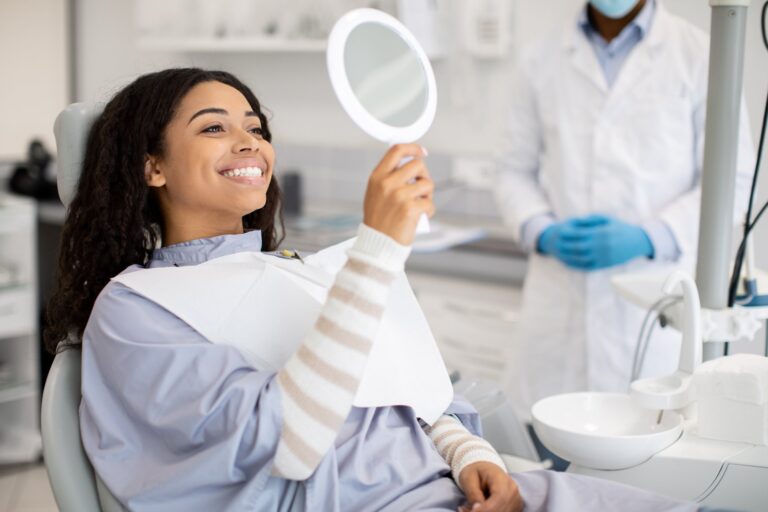 patient looking at mirror after dental treatment in clinic